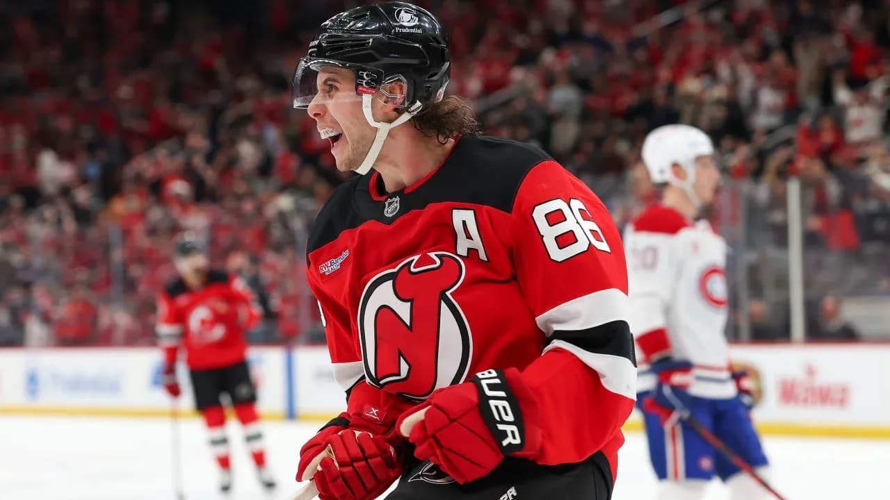 Hockey player celebrating goal in Devils jersey Hockey player celebrating goal in Devils jersey