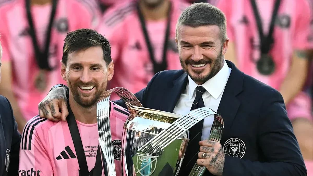 Messi and Beckham holding trophy after match Messi and Beckham holding trophy after match