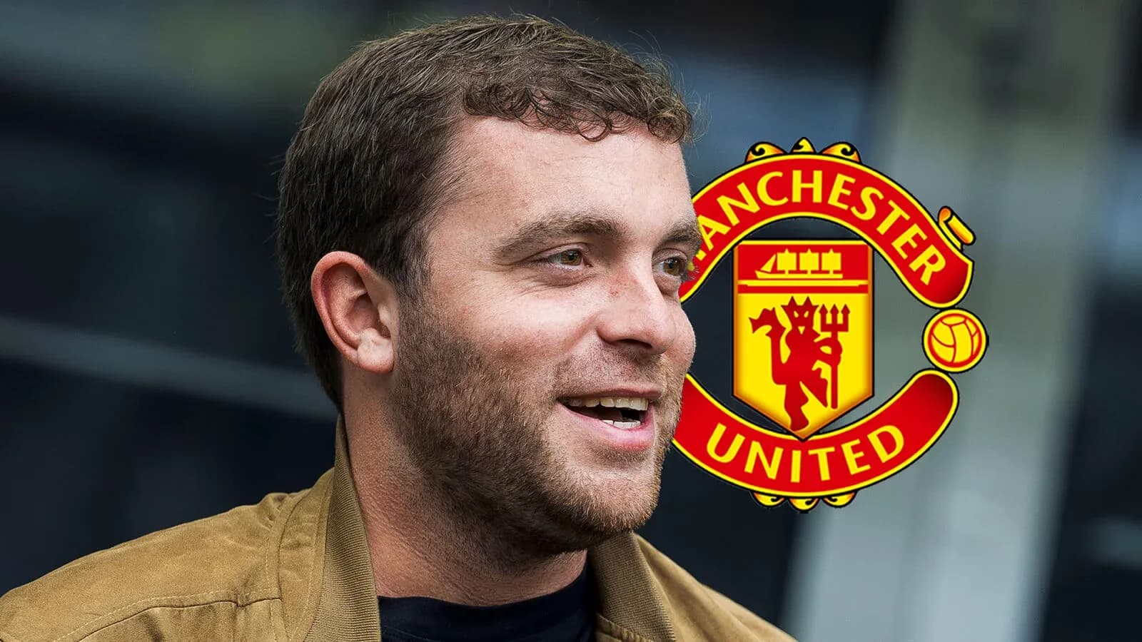 Shirted man smiling with Manchester United logo behind Shirted man smiling with Manchester United logo behind