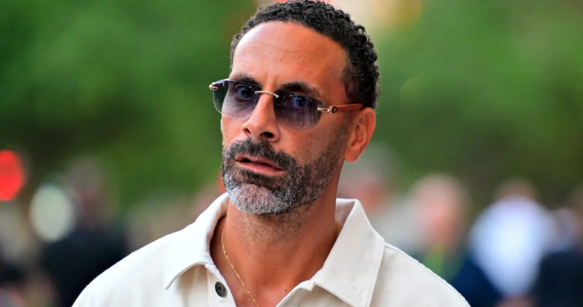 Man wearing sunglasses, walking outdoors Man wearing sunglasses, walking outdoors